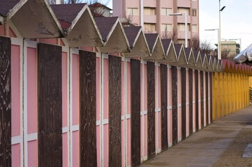 A set of pink beach huts with a wooden door in a bathhouse (Pesaro, Italy, Europe)