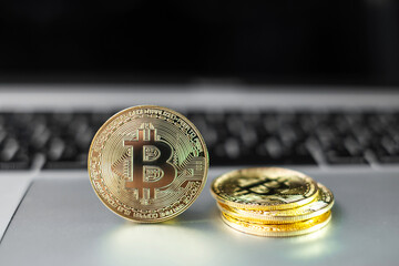 golden Bitcoin cryptocurrency coin stack on laptop keyboard, Crypto is Digital Money within the blockchain network, is exchanged using technology and online internet exchange. Financial concept