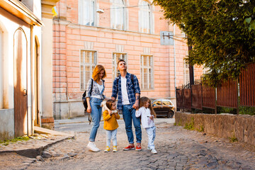 Obraz premium The family are walking around the old town at the summer