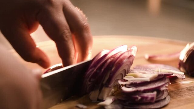 Fast chopping of fresh onions with a knife close-up. 