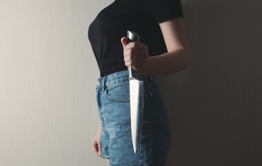 girl holding a kitchen knife to protect herself
