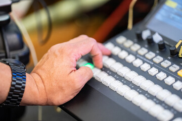 Focus on man's hand how control the livestreaming switcher board.