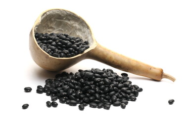 Black beluga lentils pile with gourd calabash spoon isolated on white background