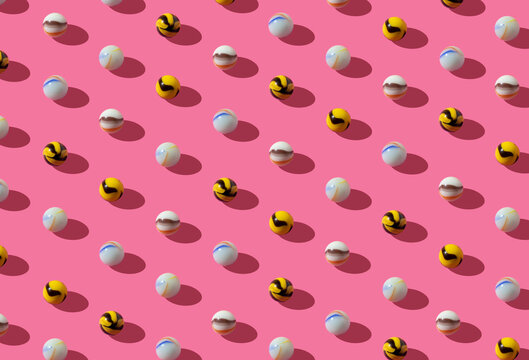 Pattern with vintage glass marbles in playful colors on a pink background. Retro isometric creative lyout.