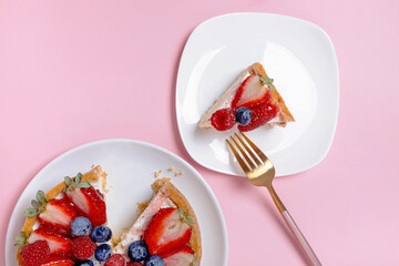 Cheesecake with fresh berries on the pink background
