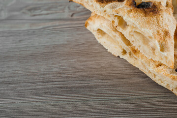 Dough for pinsa romana and scrocchiarella gourmet italian cuisine on grey wooden background. Traditional dish. Food delivery from pizzeria