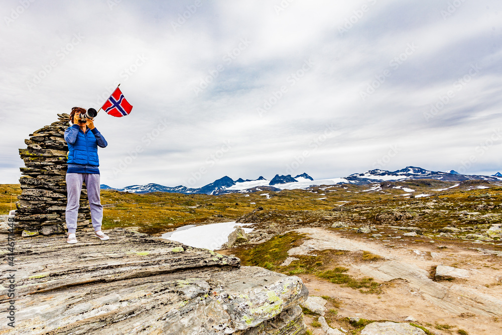 Poster tourist with camera in norway mountains