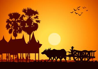 Fototapeta na wymiar country life of Asia farmer ride cart to go to do work sunrise time,silhouette style
