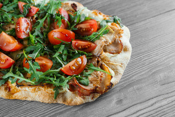 Scrocchiarella gourmet italian cuisine on grey wooden background. Pinsa romana traditional dish....