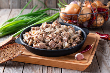 Stew meat with mushrooms in a creamy sauce in a frying pan
