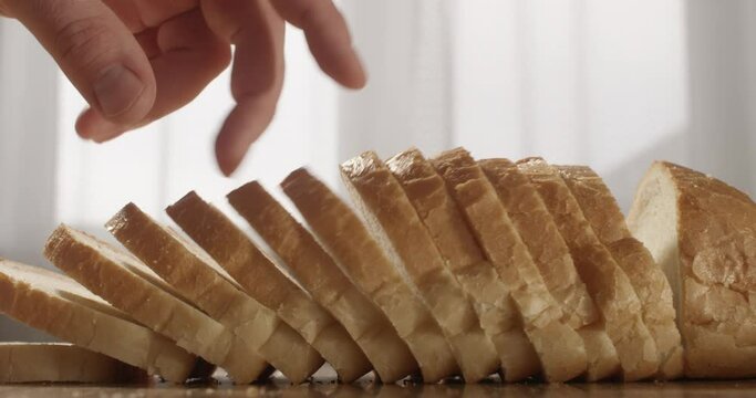 Sliced Bread on the Table with Fingers Counting Slices Shot on Red Camera
