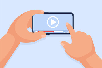 Hands hold a smartphone and touch the screen. Video player on the screen. Video content marketing concept. Online training, video conferencing and webinars, publishing information in video.