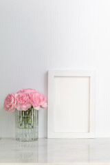 White frame mockup with pink carnations on marble portrait copy space.  Simple, clean and fresh mockup for art or text display on white background for Spring, Nursery, Wedding, Party, Mother's Day.