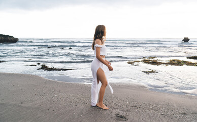 Barefoot woman walking on beach