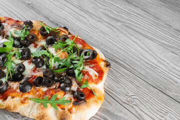 Pinsa romana gourmet italian cuisine on grey wooden background. Scrocchiarella traditional dish....