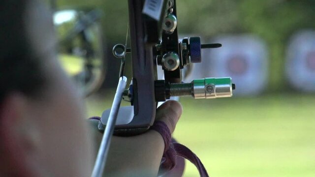 Aiming during olympic archery target practice, close up slow motion shot