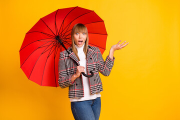 Photo of unsatisfied lady raise hand rain drop open mouth look camera isolated on yellow color...