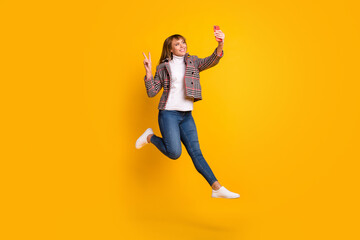 Fototapeta na wymiar Full size portrait of carefree person make selfie fingers show v-sign wear plaid isolated on yellow color background