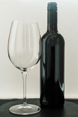 Bottle of wine and glass on white background