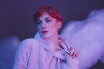 fashion portrait of a modern girl with an androgynous appearance in pink clouds