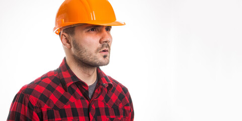 A man in a plaid shirt and a construction helmet on a white background. Concept Labor Day.