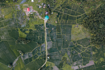 Fototapeta premium Amazing Aerial Drone Shot of Agriculture in Rice Fields in a Small Farmer Countryside Village in the Philippines