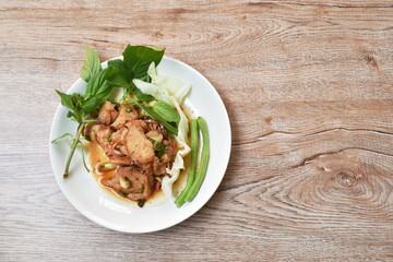 spicy roasted pork Thai salad eat with fresh basil leaf and cabbage on plate