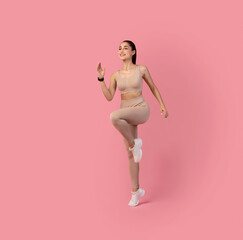 Woman Running And Exercising Isolated On Pink Background