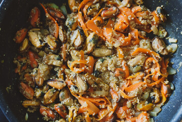 Cooking of traditional Moroccan couscous with mussels.
