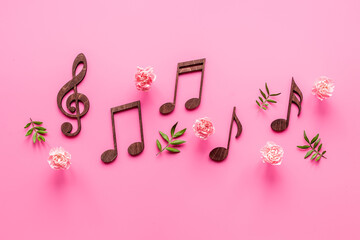 Flat lay of musical notes with flowers. Love songs concept