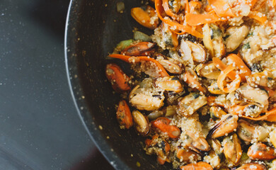 Cooking of traditional Moroccan couscous with mussels.