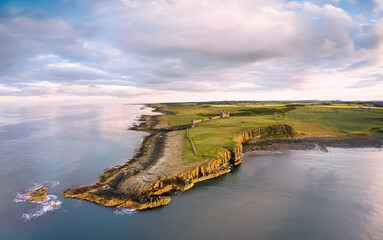 View from above on Embleton bay and green agricultural fields at Sunset. England countryside. UK