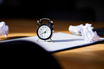 Modern workplace, wooden office desk in hardlight, sunligt with clock, sheet of paper, laptop, notebook, crumpled paper balls, Change Your Mindset, plan B, time to set new goals, business