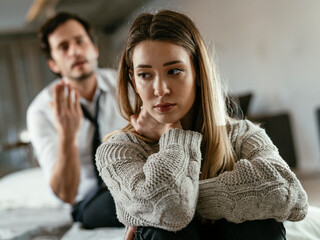Husband and wife are arguing at home. Angry man is yelling at his wife..