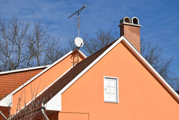 House roof with smoke stack and antennas