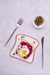 Sandwich with beetroot sauce and egg