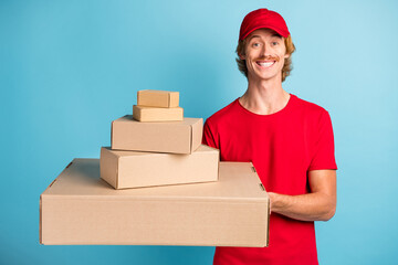 Photo of friendly young working person hands hold different size boxes isolated on blue color background