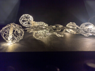 Photo of New Year's lighting on a black background. Awesome garland decoration. Festive decoration for Christmas and New Year. Low key. View from above.