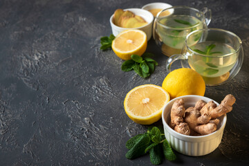 Ginger tea with mint, lemon and honey on concrete background. Top view