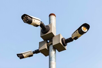 Three CCTV camera on a tall pole at the park