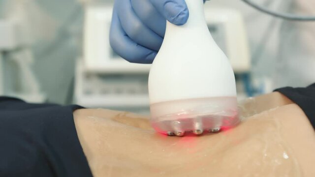Close up of a doctor's hand performing a rejuvenation procedure on a patient's skin. Skin rejuvenation with ultrasound. Beauty salon