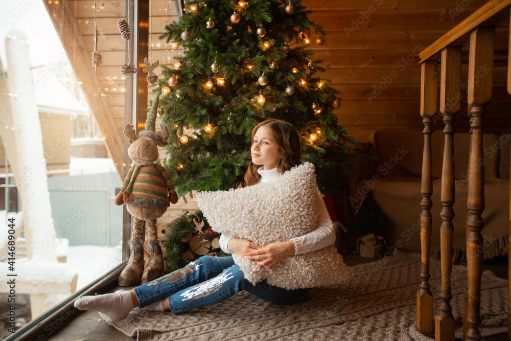 Wall mural beautiful teenage girl at home near christmas tree