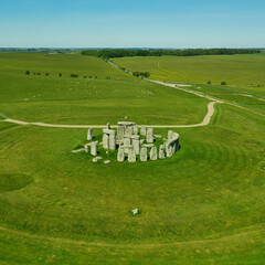 Square - Aerial view of Stonehenge on a sunny day in summer with no people around. This is a historic site with a ring of standing stones, it was believed to be a burial site. - 414689456