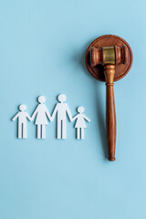 Family law or divorce concept. Family figure with judge gavel, top view