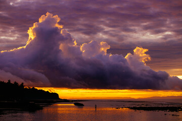 Fisherman catching fish during sunrise in the sea in Bali indonesia 