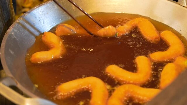 Deep-frying Chinese Crullers (Pa Tong Ko), Popular Street Food In Thailand. close up