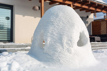 Beautiful winter garden with snow igloo at sunny day. Poland