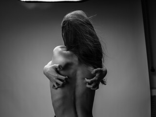 Woman black and white photography portrait rear view touching back with hands