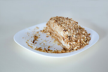 Napoleon cake, homemade. On a white plate.