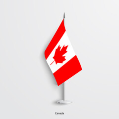 Canada table, desk flag isolated on light grey background. Canadian flag pole with shadow. 
